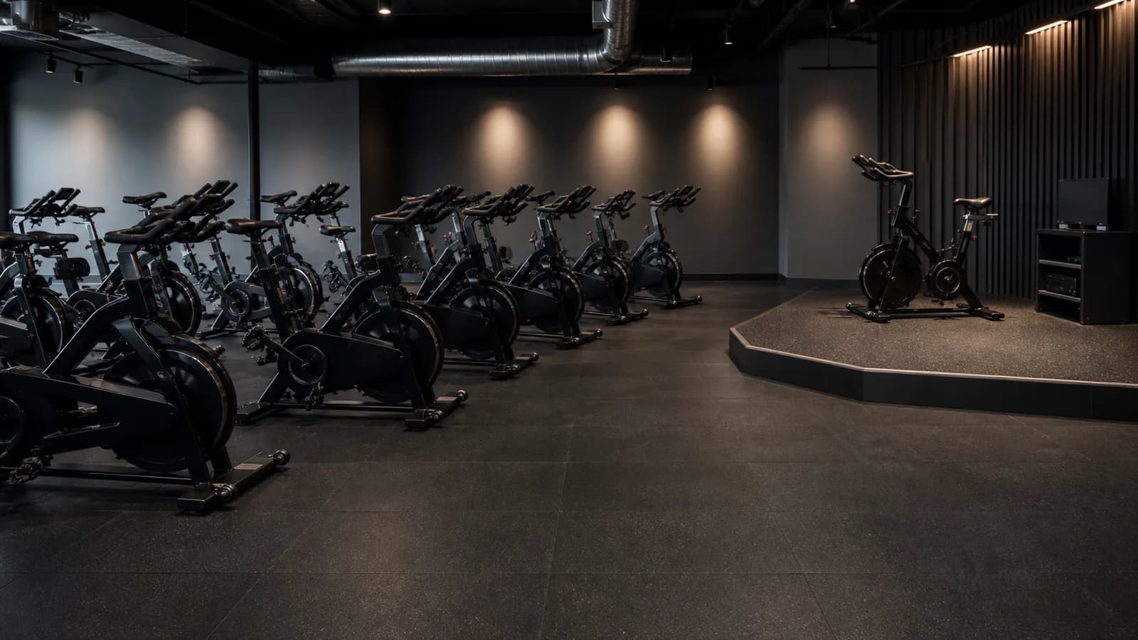 Boutique indoor cycling studio with durable dark resilient flooring