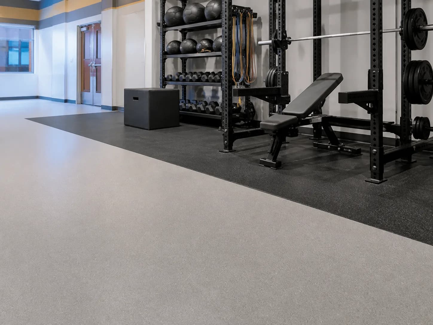 Flush transition from sports roll flooring to rubber equipment area