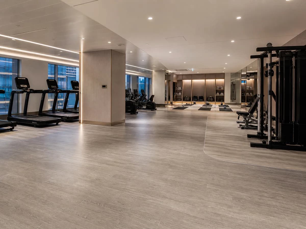 Resilient PVC flooring in a bright commercial cardio and studio area