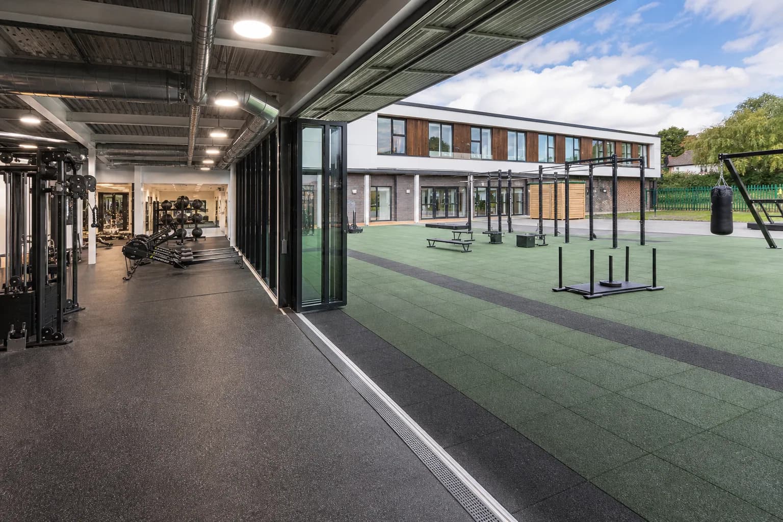 Indoor-outdoor community sports and recreation center: completed facility and full flooring concept using multi-system public-facility specification using sports rolls and rubber tiles