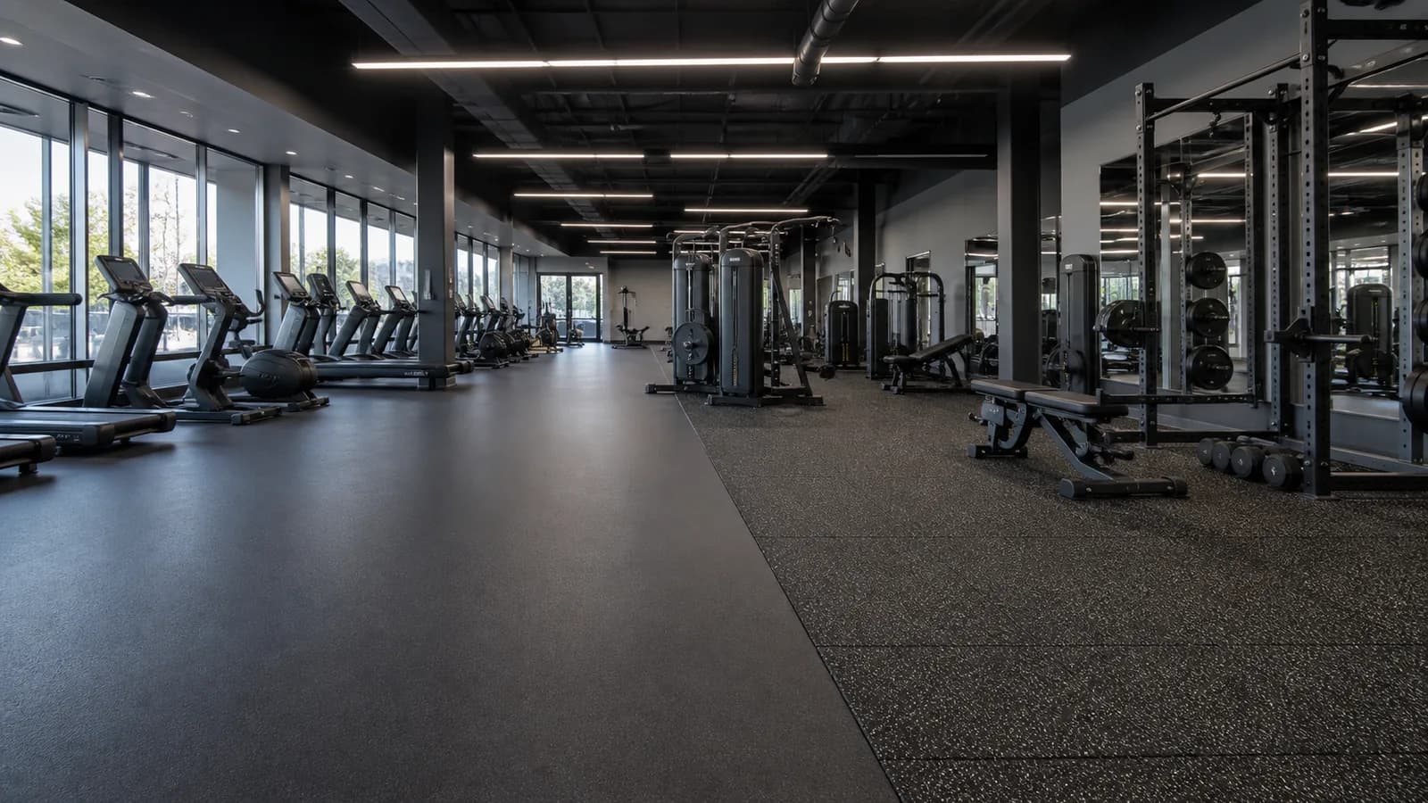 Large commercial fitness club with rubber rolls and rubber tile training zones