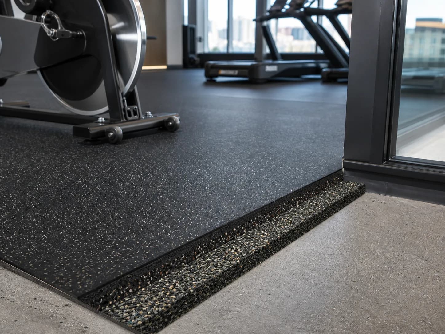 Rubber finish and resilient acoustic underlay shown over a concrete slab