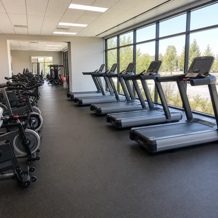 Bright cardio area with seamless rubber roll flooring
