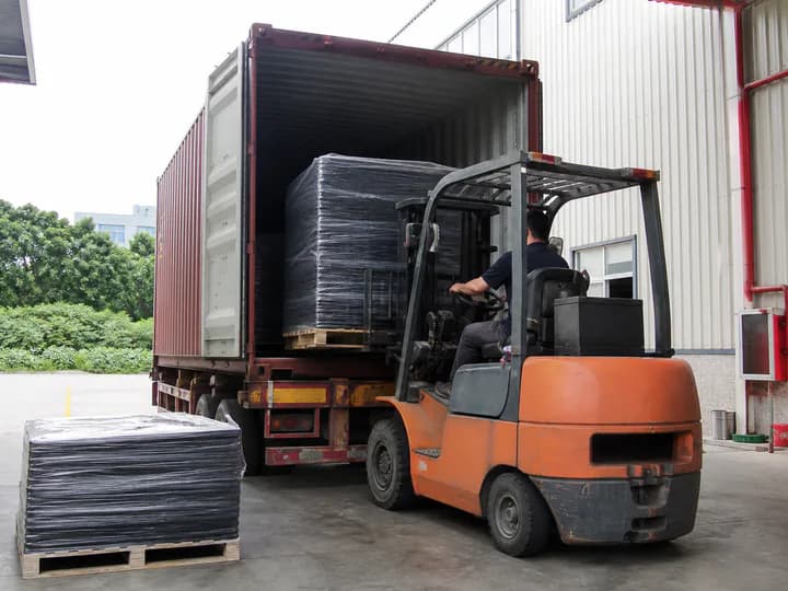 Packaged rubber flooring loaded into a shipping container