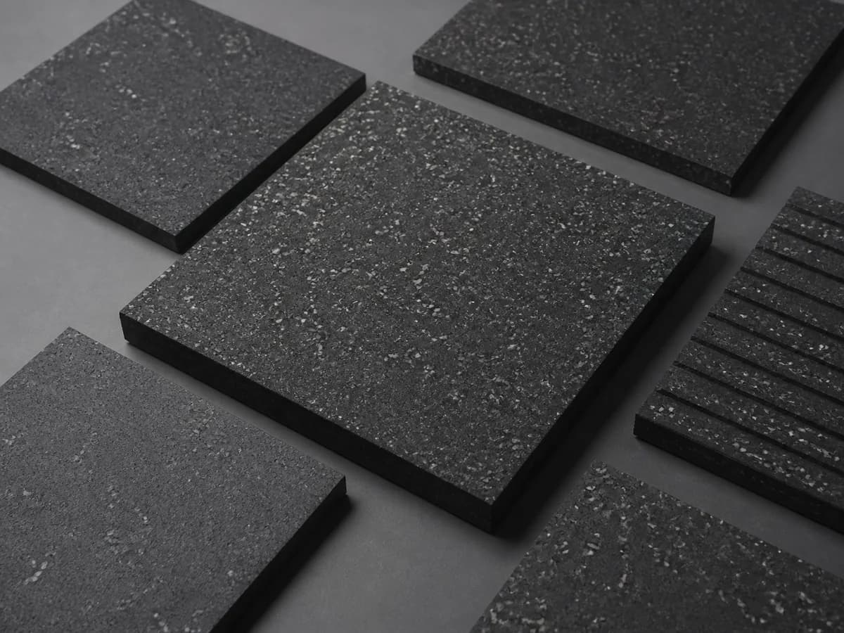 Patterned resilient floor tiles arranged to show surface design and clean edges