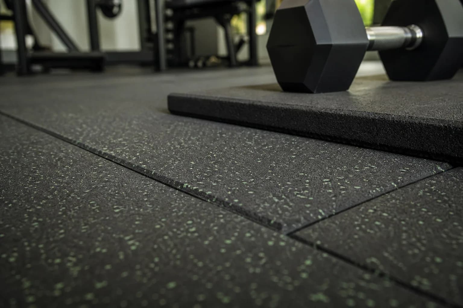 Mid-size neighborhood commercial gym: material texture, scale and seam detail using commercial interlocking rubber tiles with local heavier protection