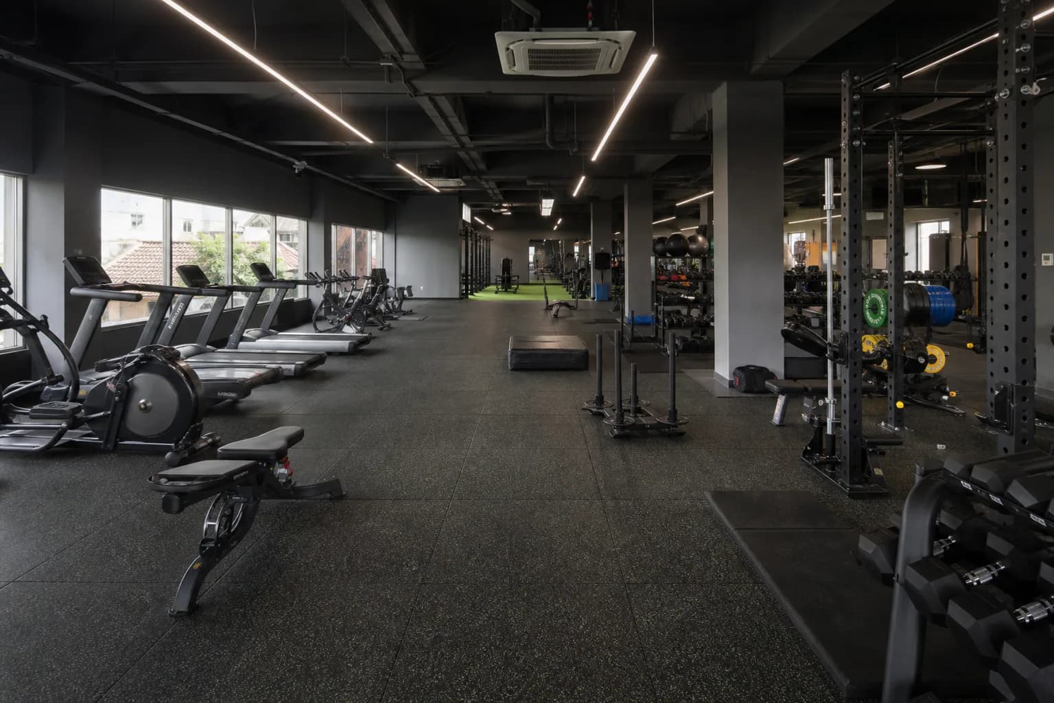 Mid-size neighborhood commercial gym: overall floor zoning and circulation using commercial interlocking rubber tiles with local heavier protection