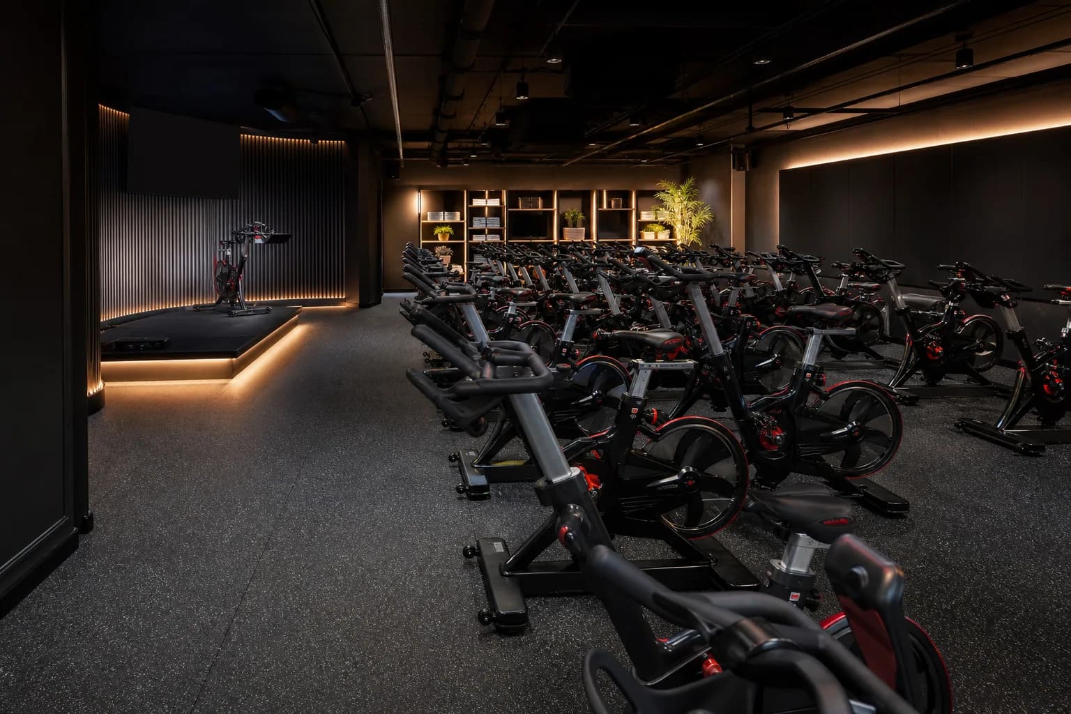 Indoor cycling studio: overall floor zoning and circulation using dense bonded rubber roll with platform and threshold details