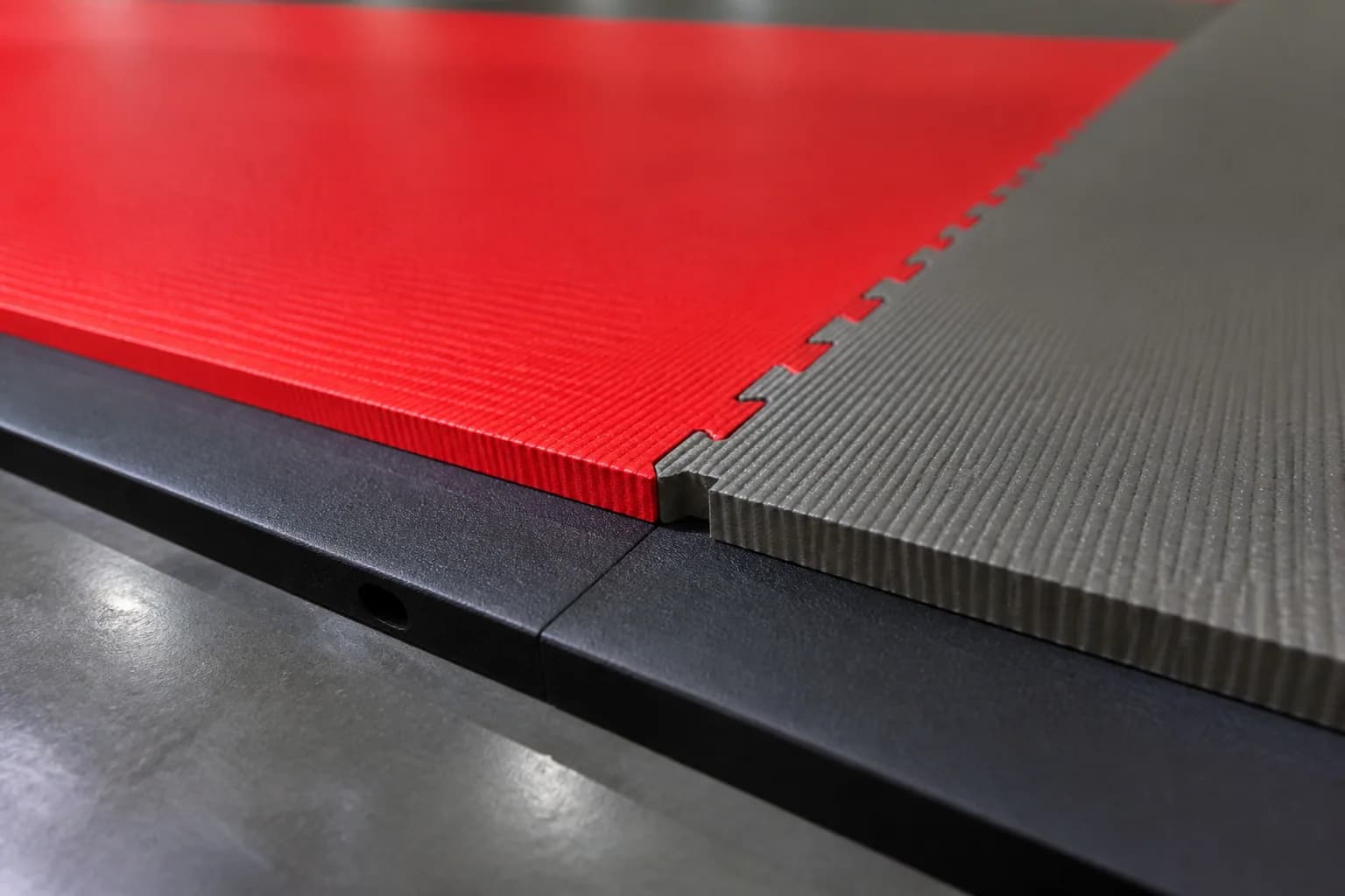 Judo and multi-discipline martial arts academy: material texture, scale and seam detail using textured interlocking tatami mat field with controlled perimeter restraint