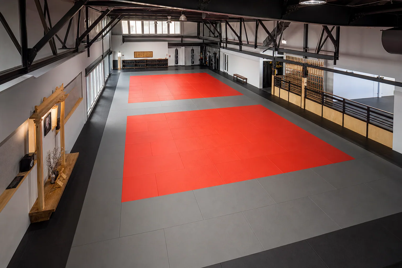 Judo and multi-discipline martial arts academy: overall floor zoning and circulation using textured interlocking tatami mat field with controlled perimeter restraint