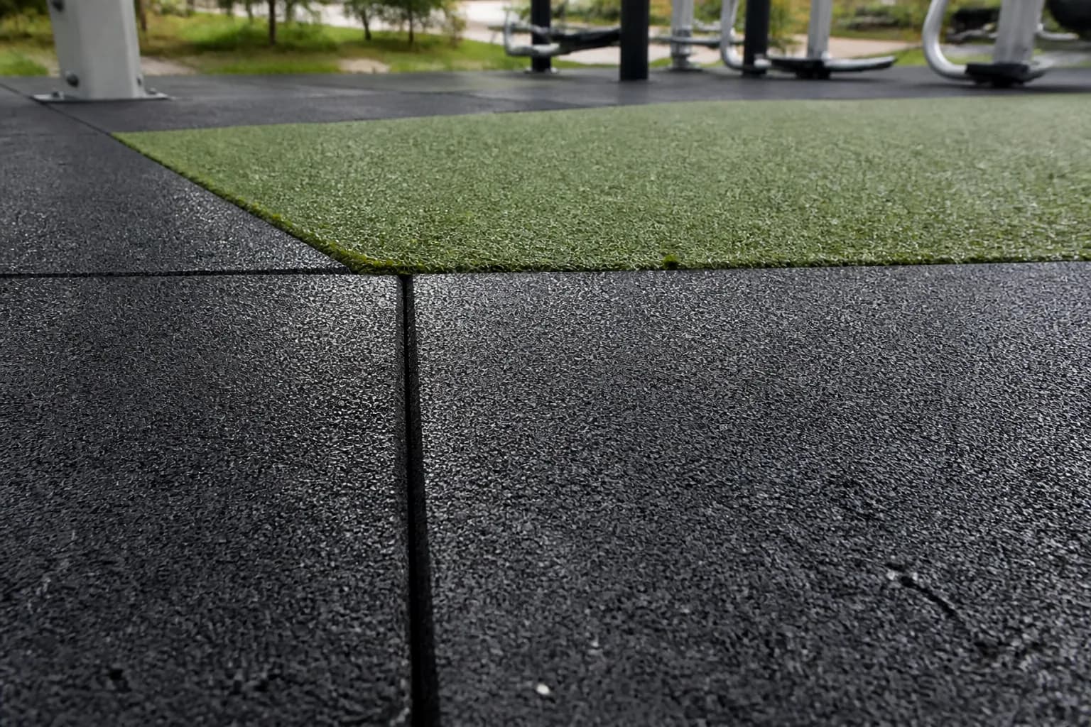 Public outdoor fitness park: material texture, scale and seam detail using weather-resistant rubber tiles and outdoor turf over a draining base