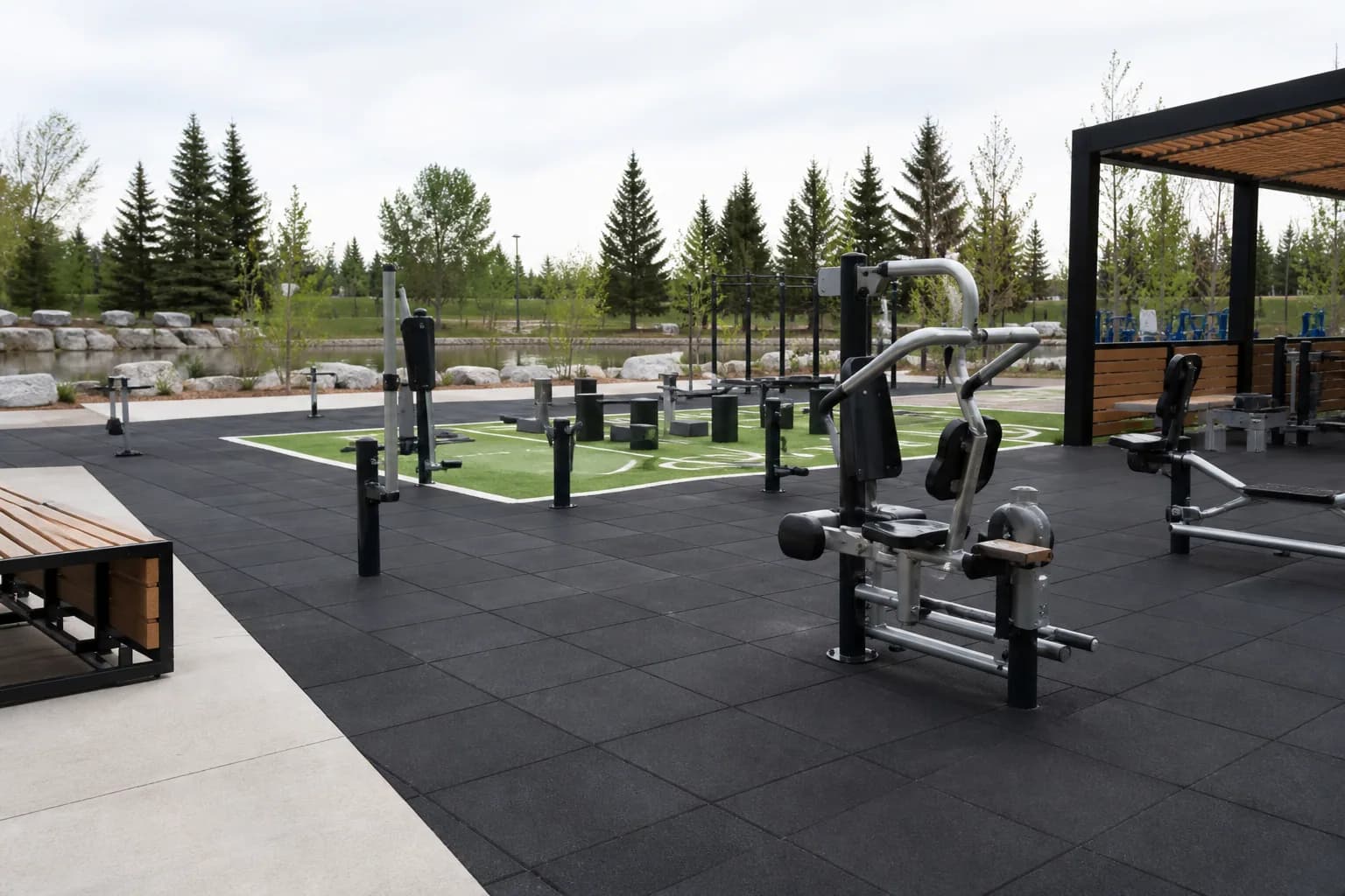 Public outdoor fitness park: completed facility and full flooring concept using weather-resistant rubber tiles and outdoor turf over a draining base