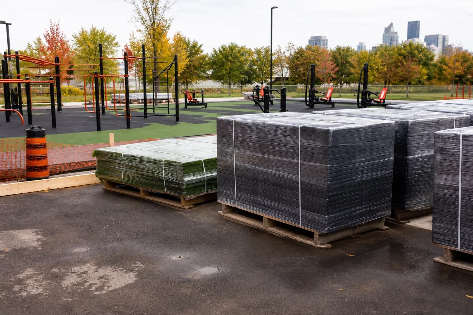 Public outdoor fitness park: product, packing or project material coordination using weather-resistant rubber tiles and outdoor turf over a draining base