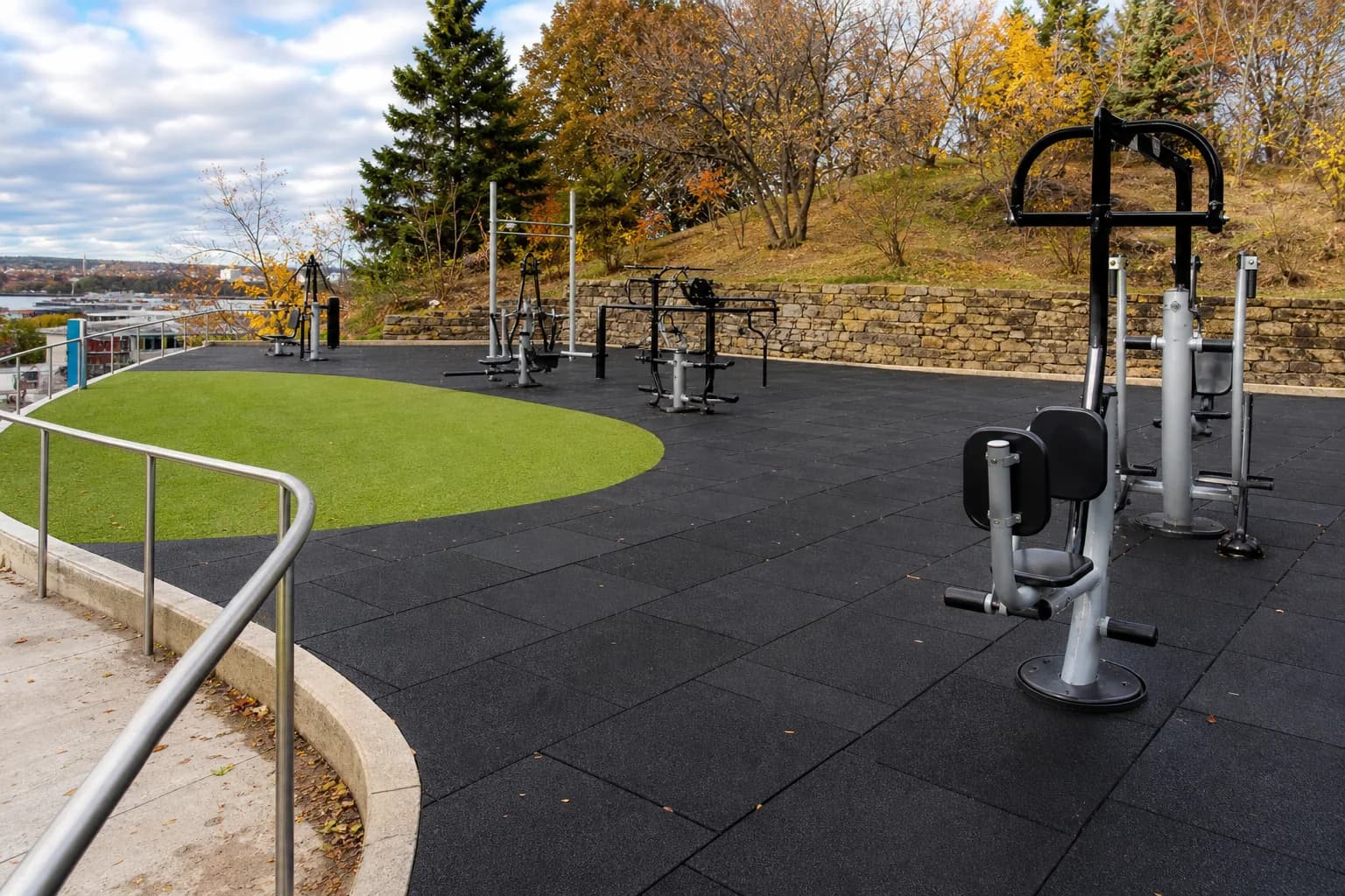 Public outdoor fitness park: overall floor zoning and circulation using weather-resistant rubber tiles and outdoor turf over a draining base