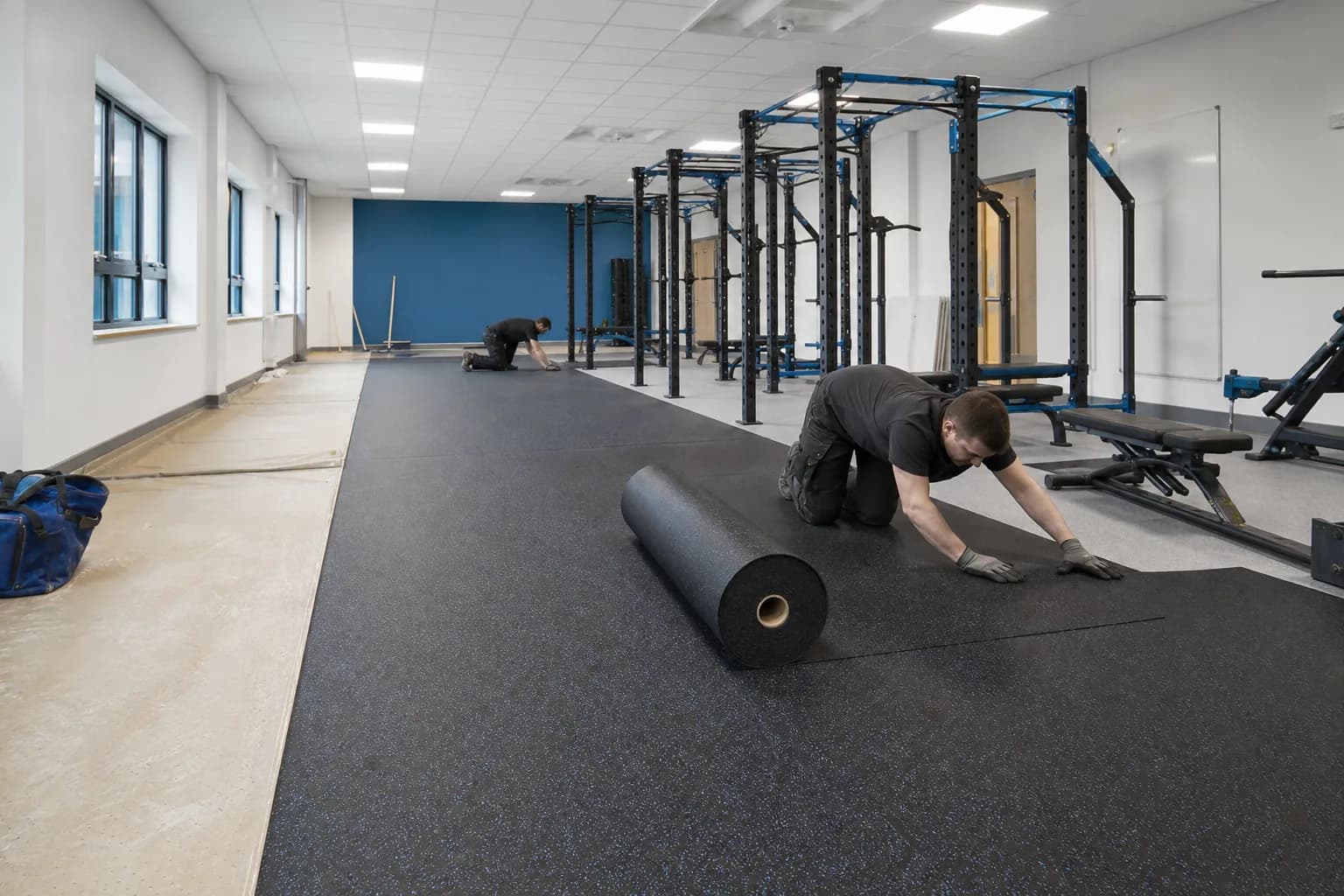 Secondary-school fitness and physical education room: subfloor, set-out and installation control using durable rubber tile and roll system with supervised activity zones